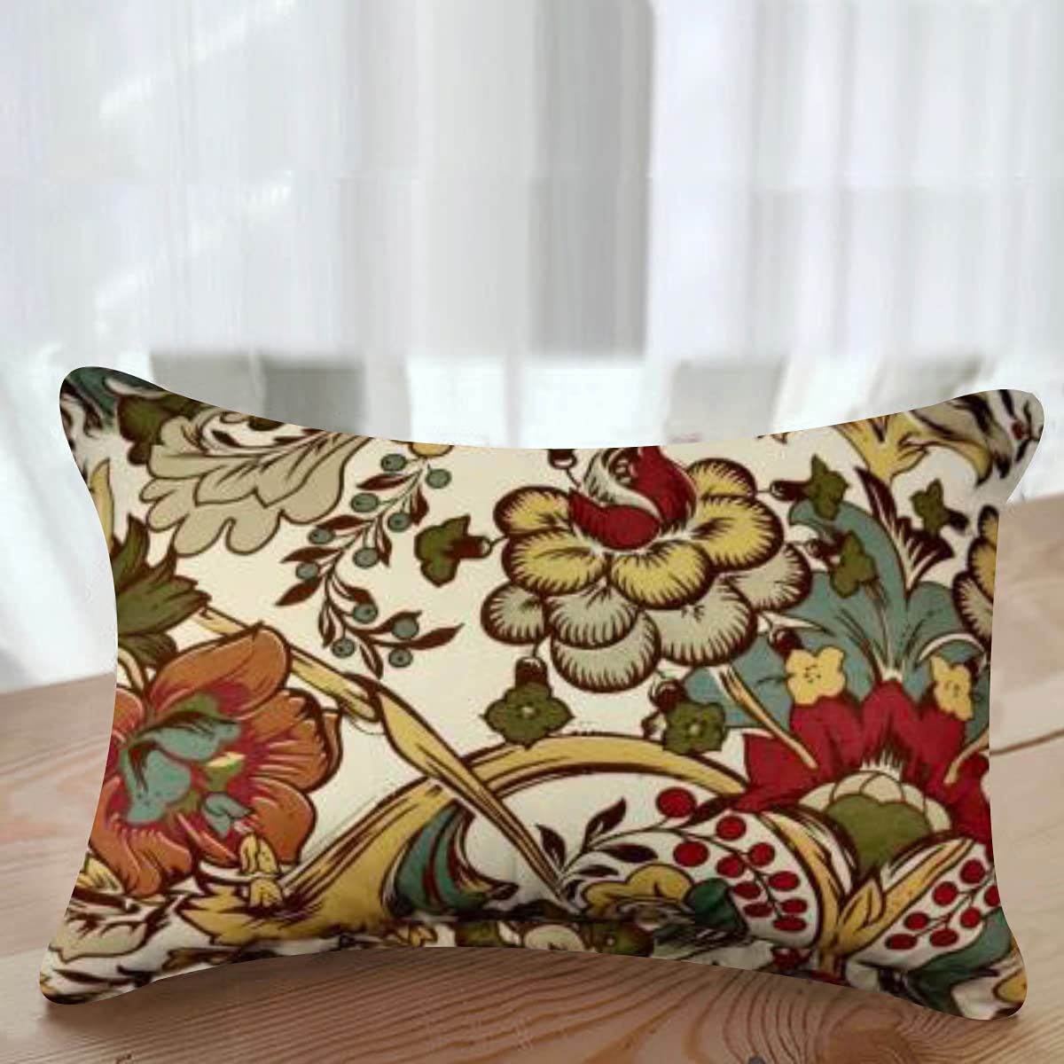 A multicolor floral patterned cushion cover on a wooden surface with a visible zipper.