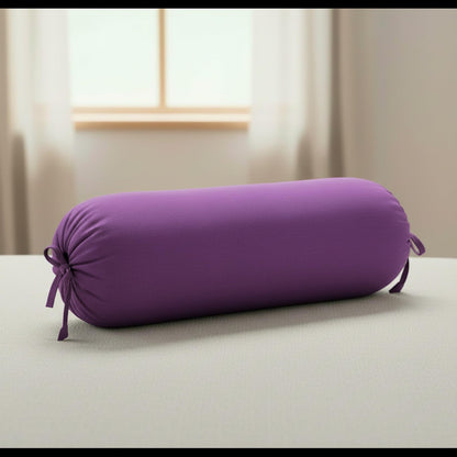 Purple cylindrical pillow on a light surface with a neutral background