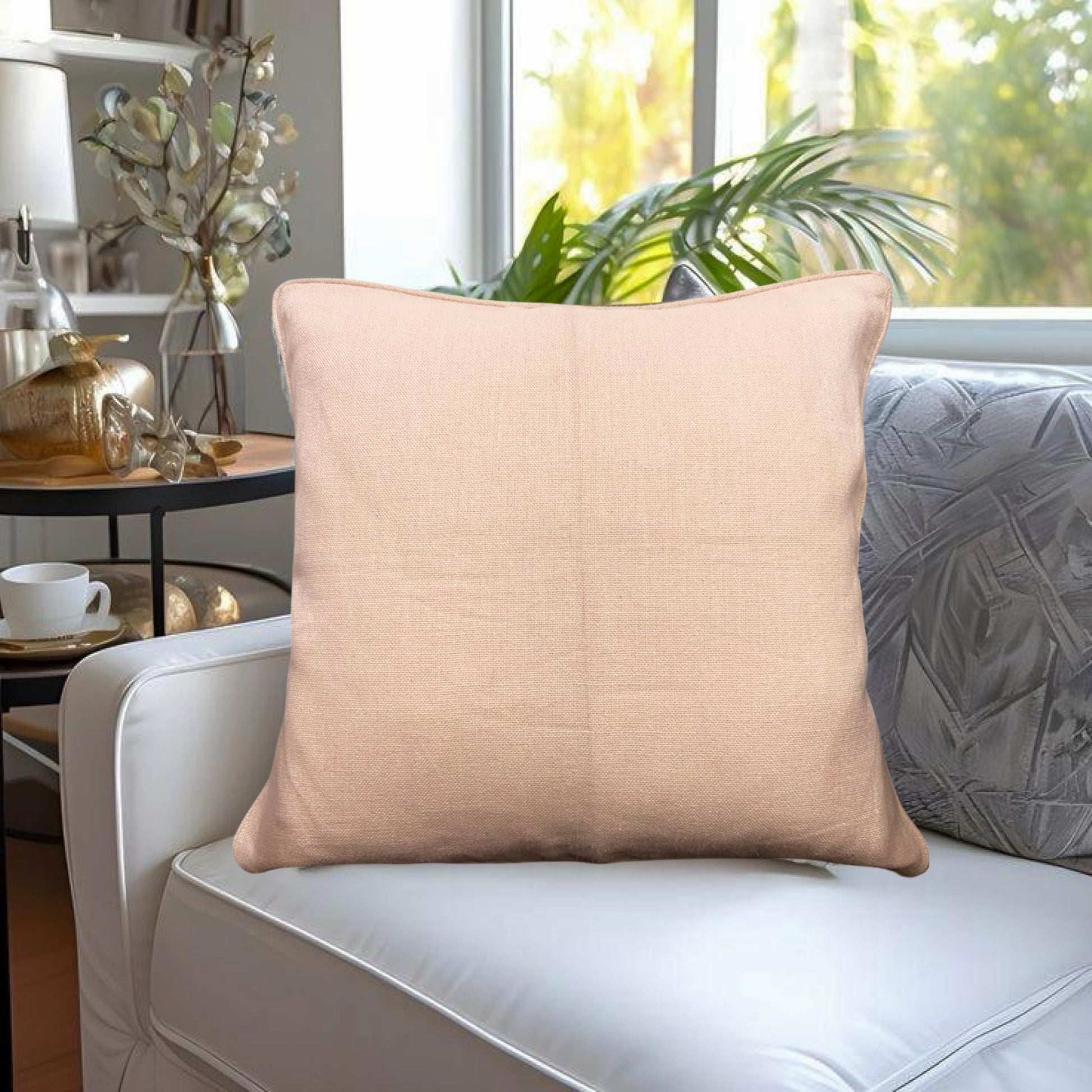 Beige pillow on a white sofa with a blurred indoor background