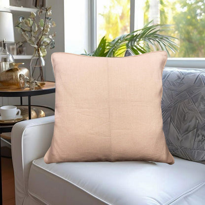 Beige pillow on a white sofa with a blurred indoor background
