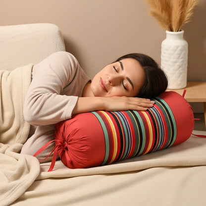 Red multi-striped bolster pillow supporting a woman sleeping peacefully.