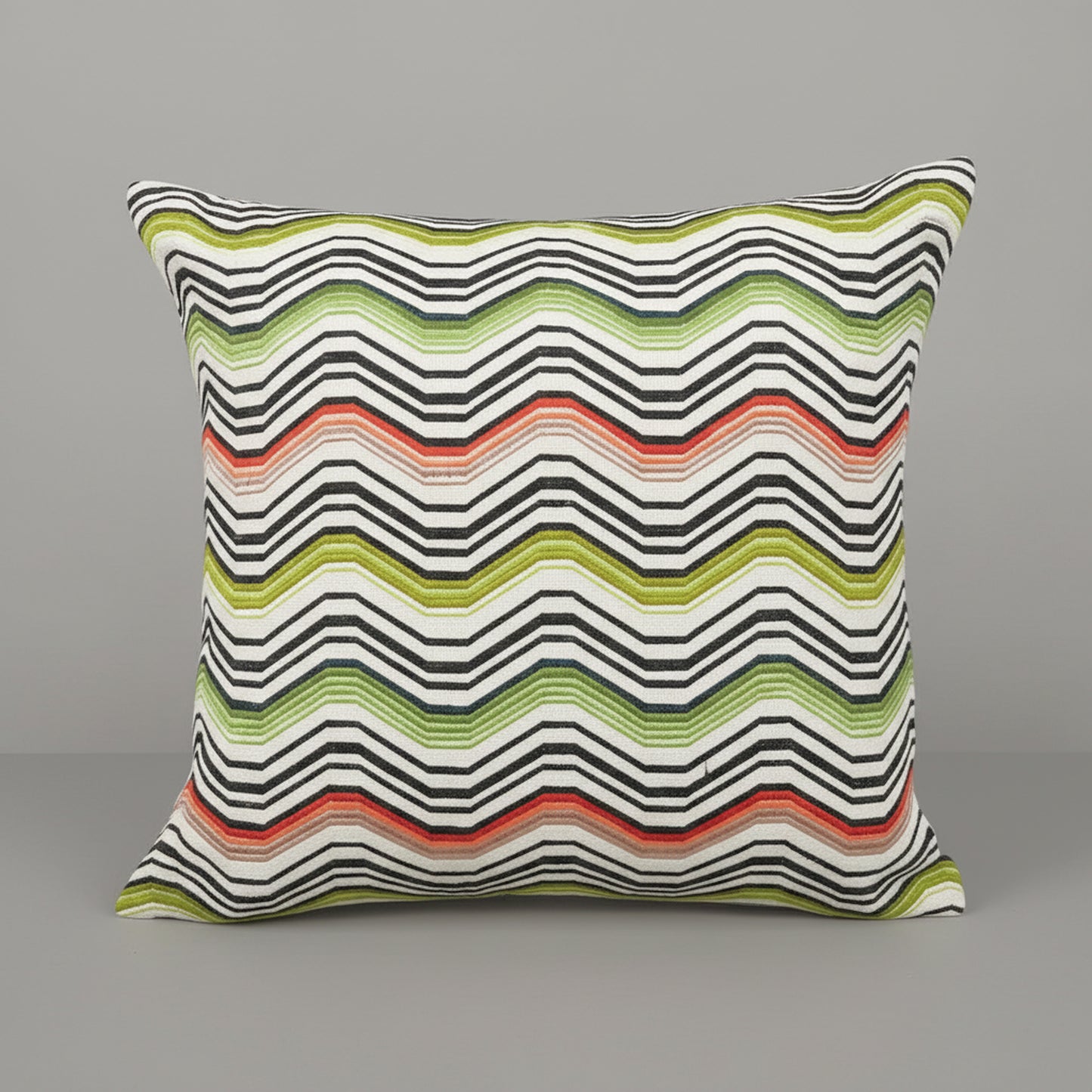 Decorative pillow with wavy striped pattern on a gray background