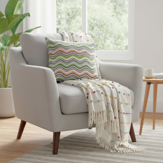 Gray armchair with a colorful pillow and blanket in a bright living room.
